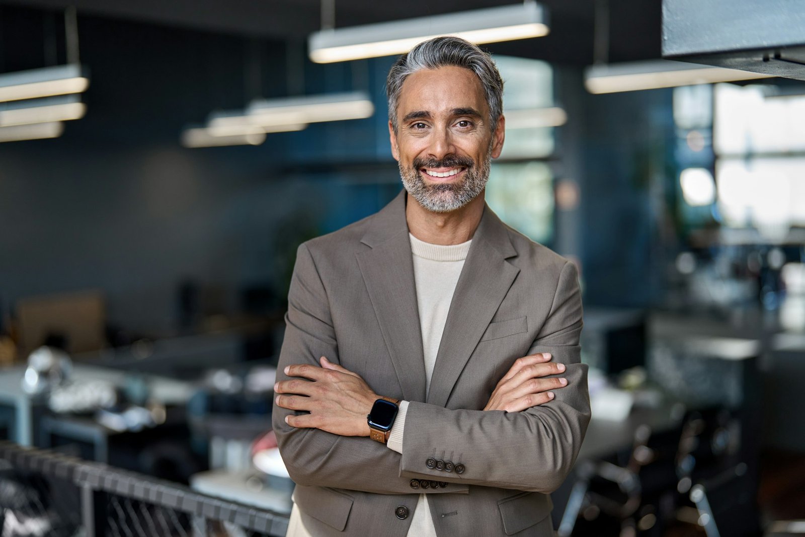 Smiling middle aged ceo business man looking at camera in office, portrait.